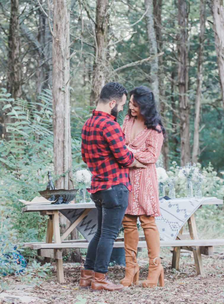 cute brunette couple in front of picnic table