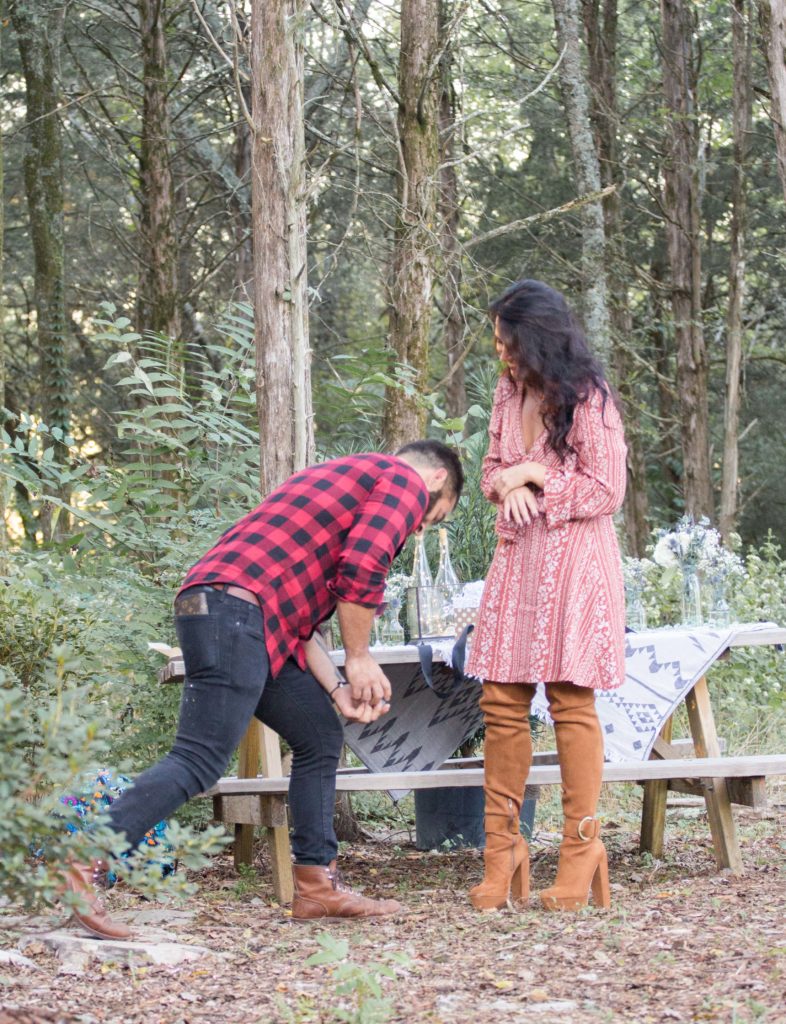 guy in buffalo plaid getting down on one knee