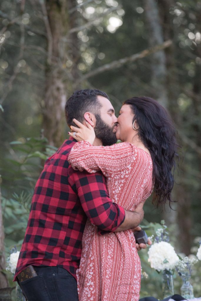 cute brunette couple kissing after proposal