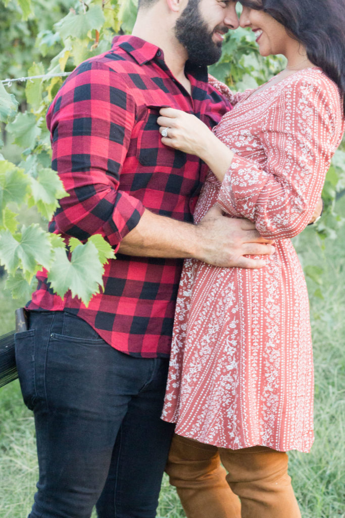 guy in red buffalo plaid and girl in knee high boots nuzzling
