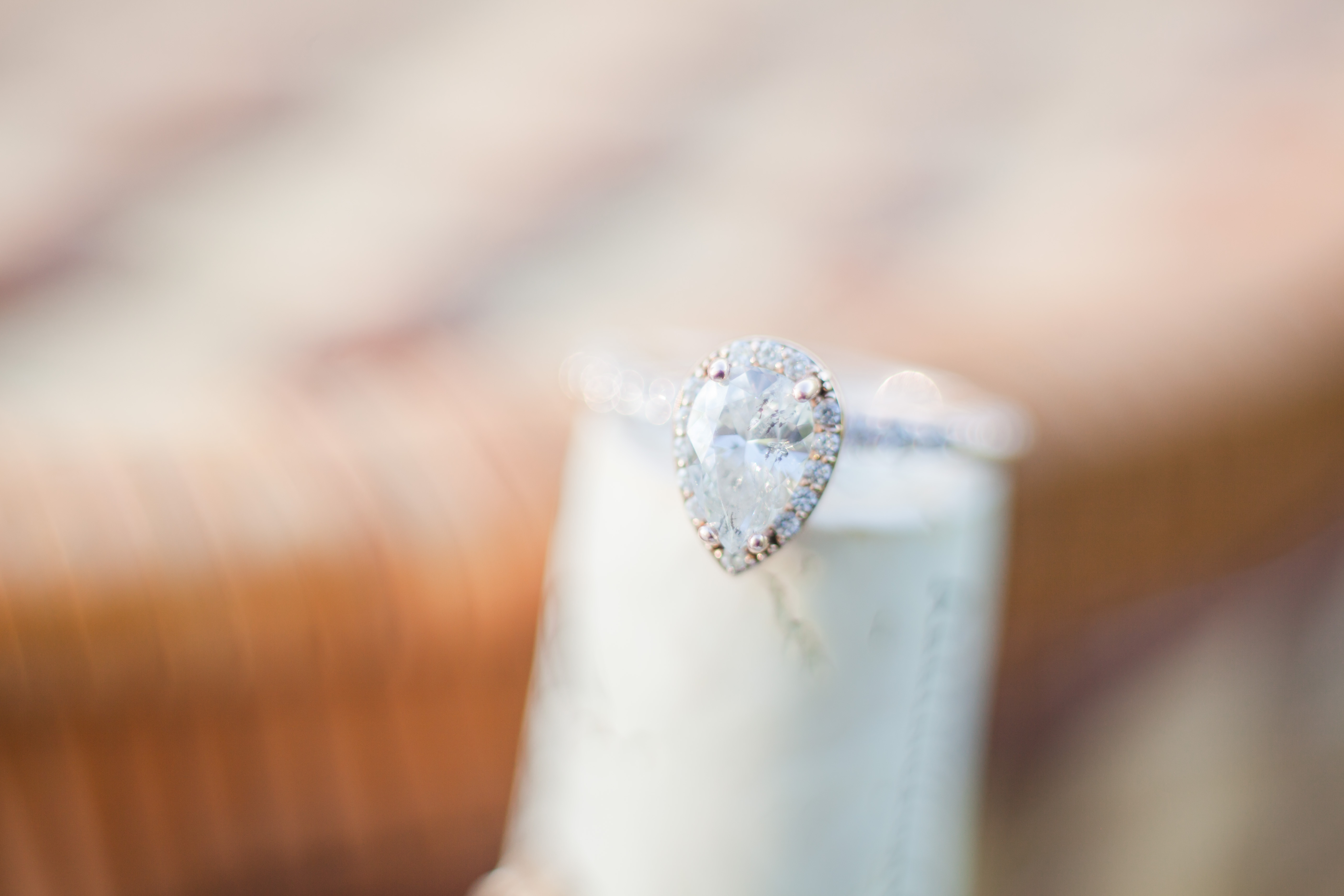 pear shaped diamond halo engagement ring on wine cork