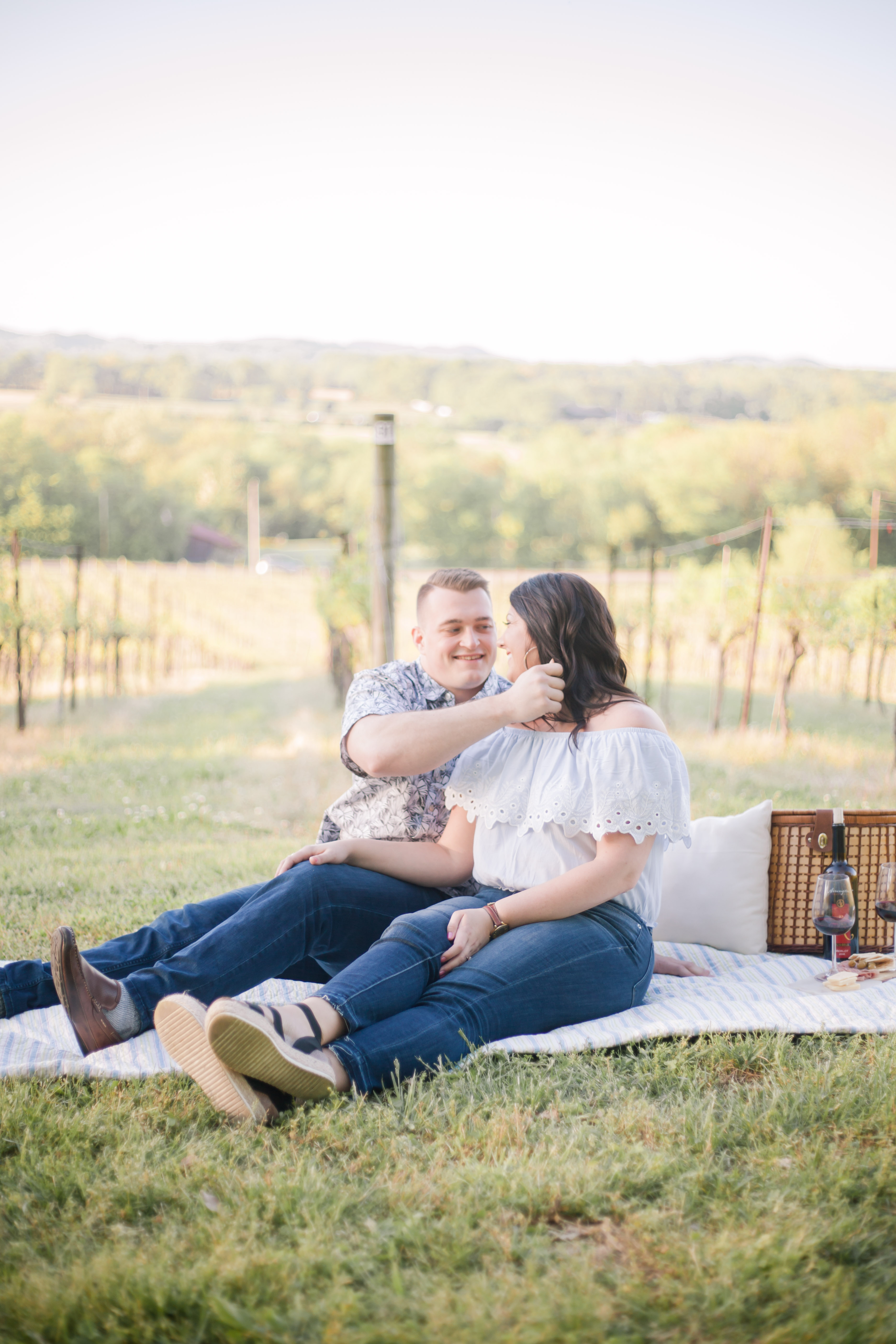 cute couple in jeans sitting on blanket picnic