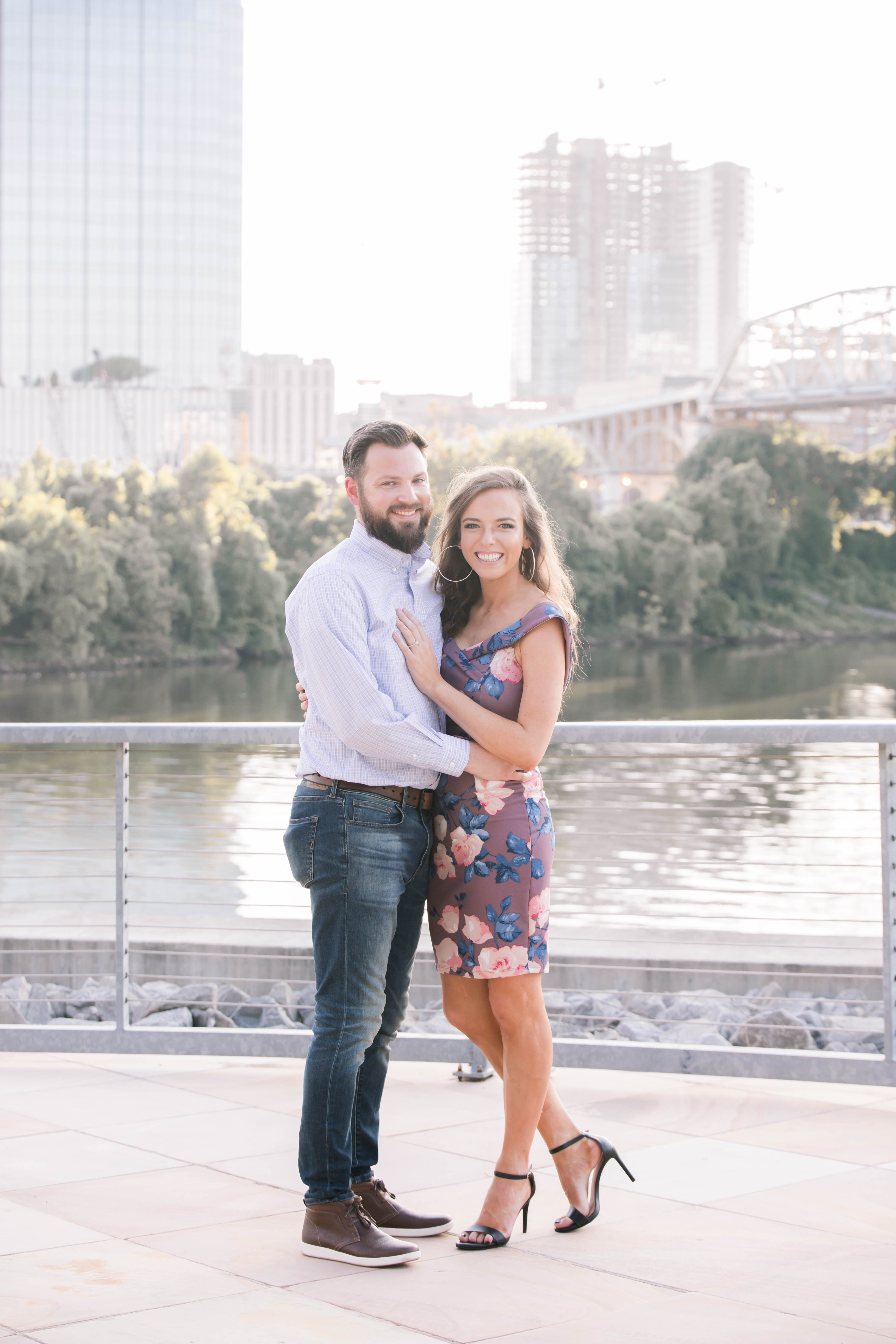 guy in jeans with beard and girl in purple dress posing
