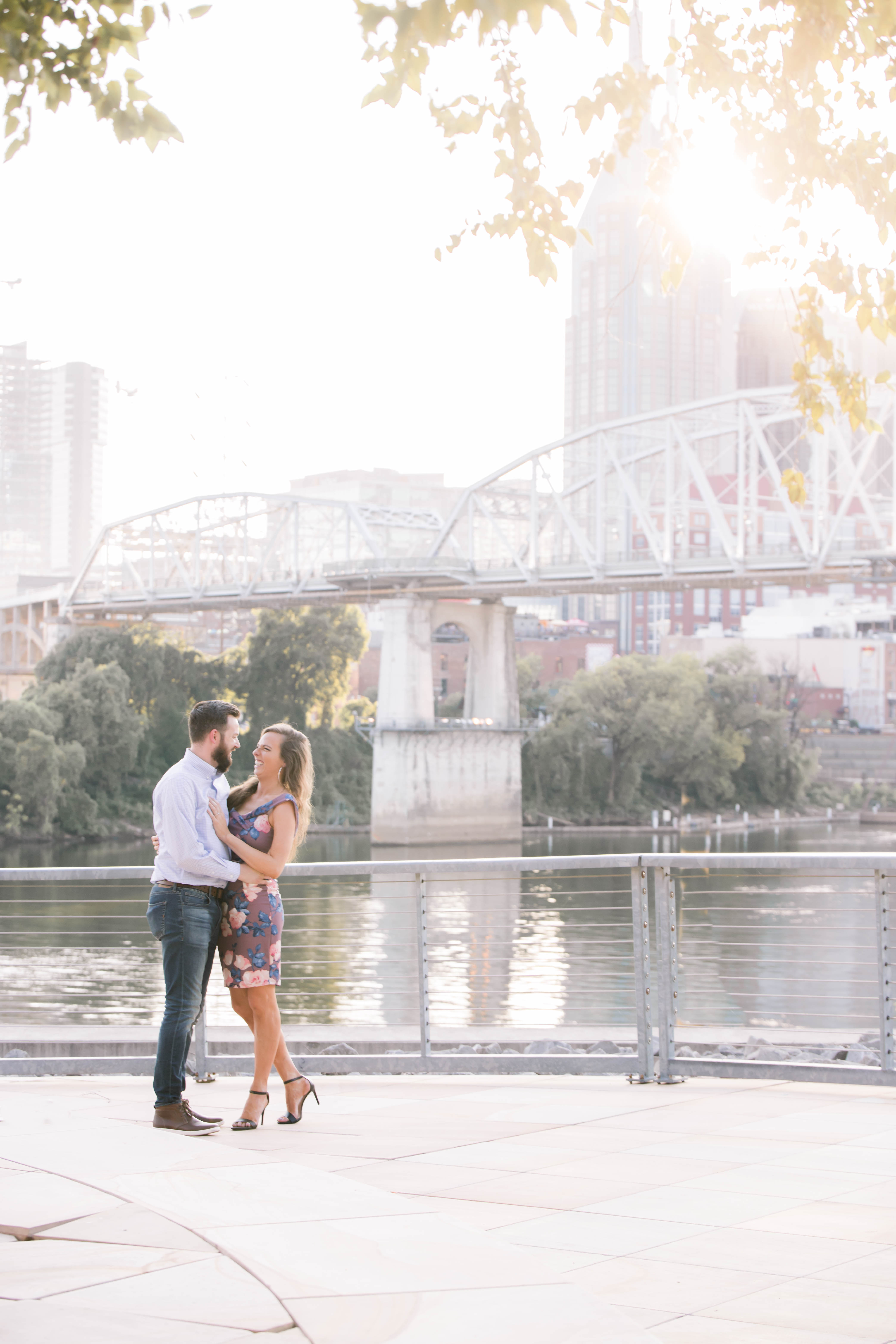 nashville skyline and couple in front of cumberland river