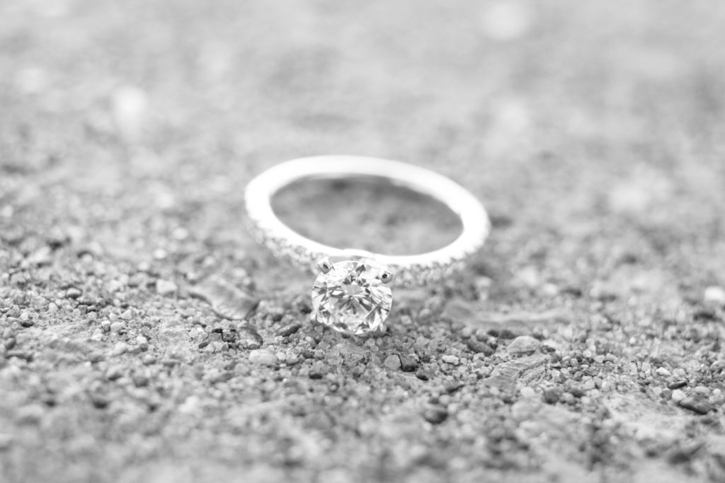 black and white photo of round diamond engagement ring