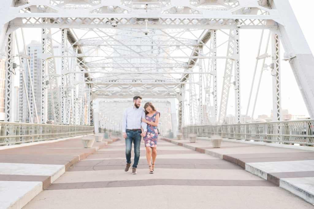 man in jeans and girl in floral dress on nashvilles pedestrain bridge