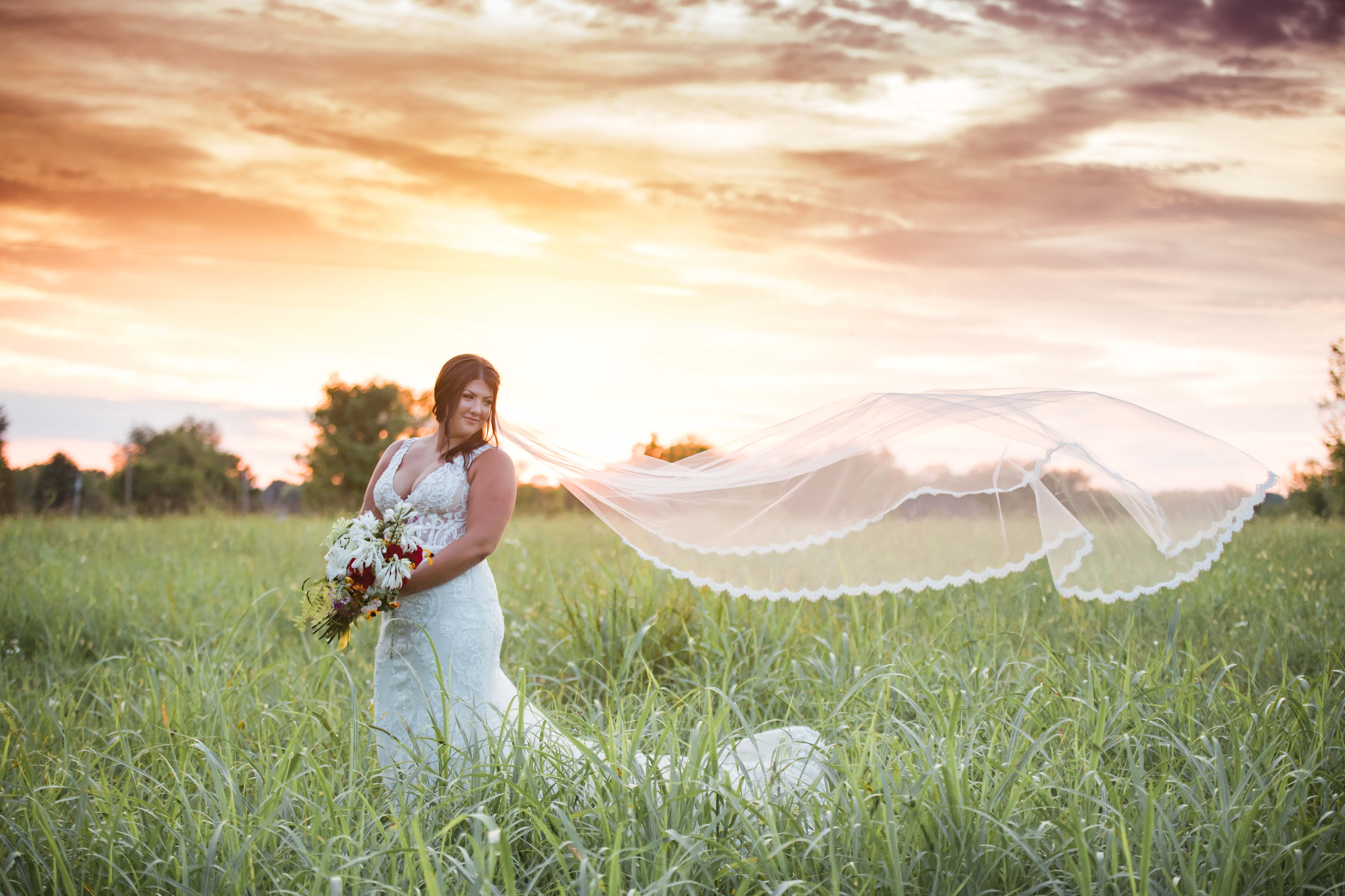 bride and beautiful sunset veil in sky