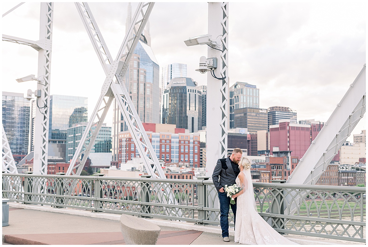 blonde bride in white gown downtown nashville skyline portraits