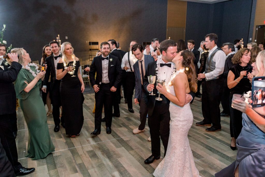 Guests celebrating at a luxury wedding reception at The Joseph Hotel Nashville, with floral arrangements and tree installation.